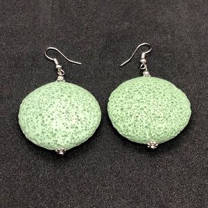 Large green volcanic dangle earrings.